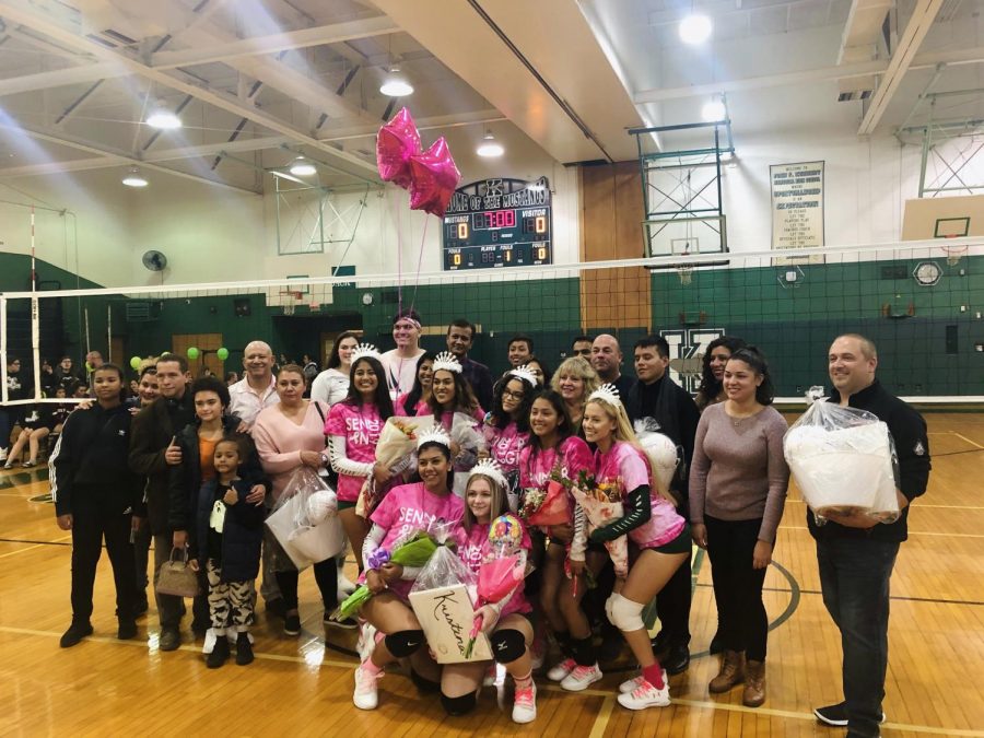 Senior girls volleyball players wear pink for their Senior Night