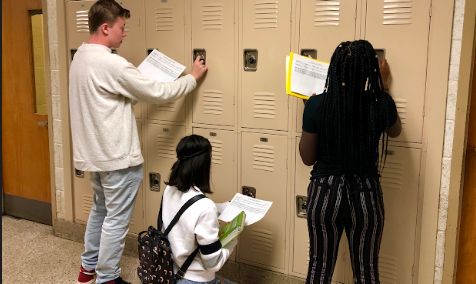 Excited JFKMHS students at their lockers with their schedules in-hand.