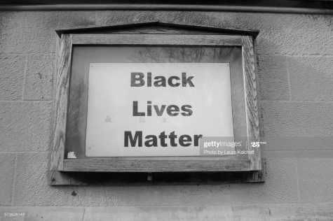 In NYC, a Black Lives Matter sign is posted where a schedule used to be. Photo Credit: Photo via Getty Images under the creative commons license.