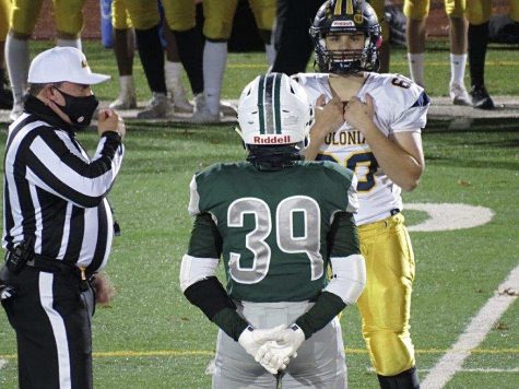 Photo 1: Courtesy to Dawn Hein. Senior Captian Michael Hein and the Captain of the Colonia Patriots preparing for the coin toss for overtime. 