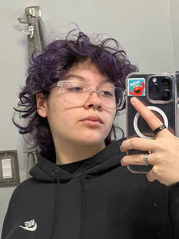 Alex Ramos, taking a mirror selfie with his new, purple-dyed hair.