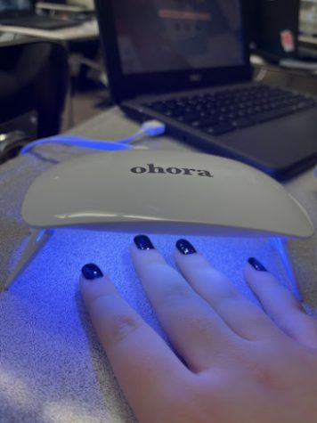 Ohora Nails under the blue light in the process of being cured.
