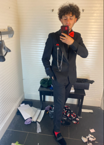 A photo of Senior Jedidiah Perez trying on his new suit. 