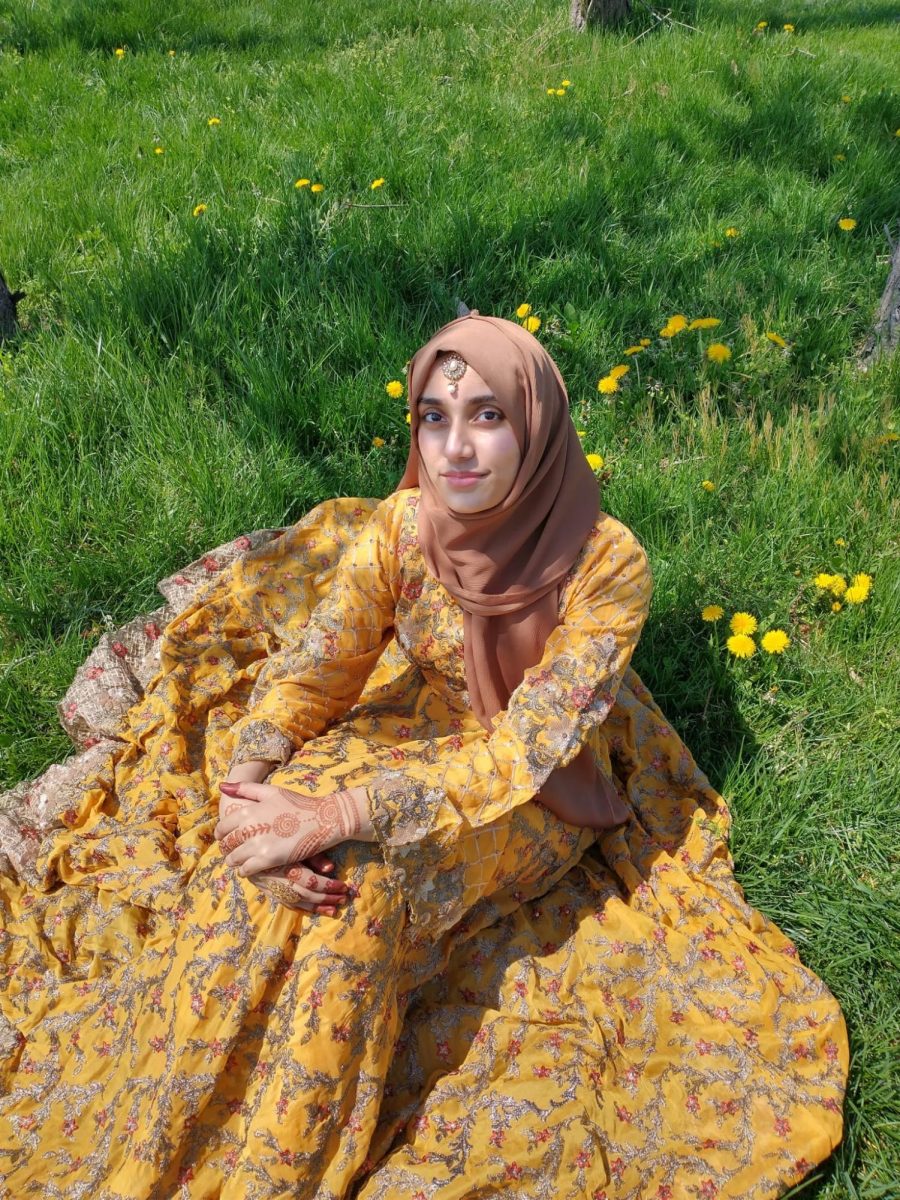 Senior Musfira Mohamed celebrates Eid under the sun in a gorgeous yellow traditional dress.