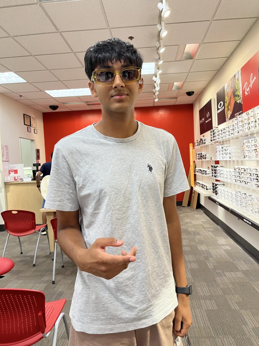 Senior Matysh Garg trying on new shades at an eyeglass store