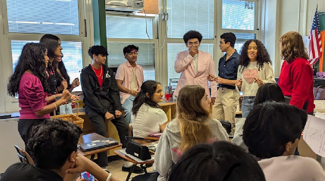 One of Concert Choir's two groups perform "Birds of a Feather" to a student in John F. Kennedy Memorial High School.