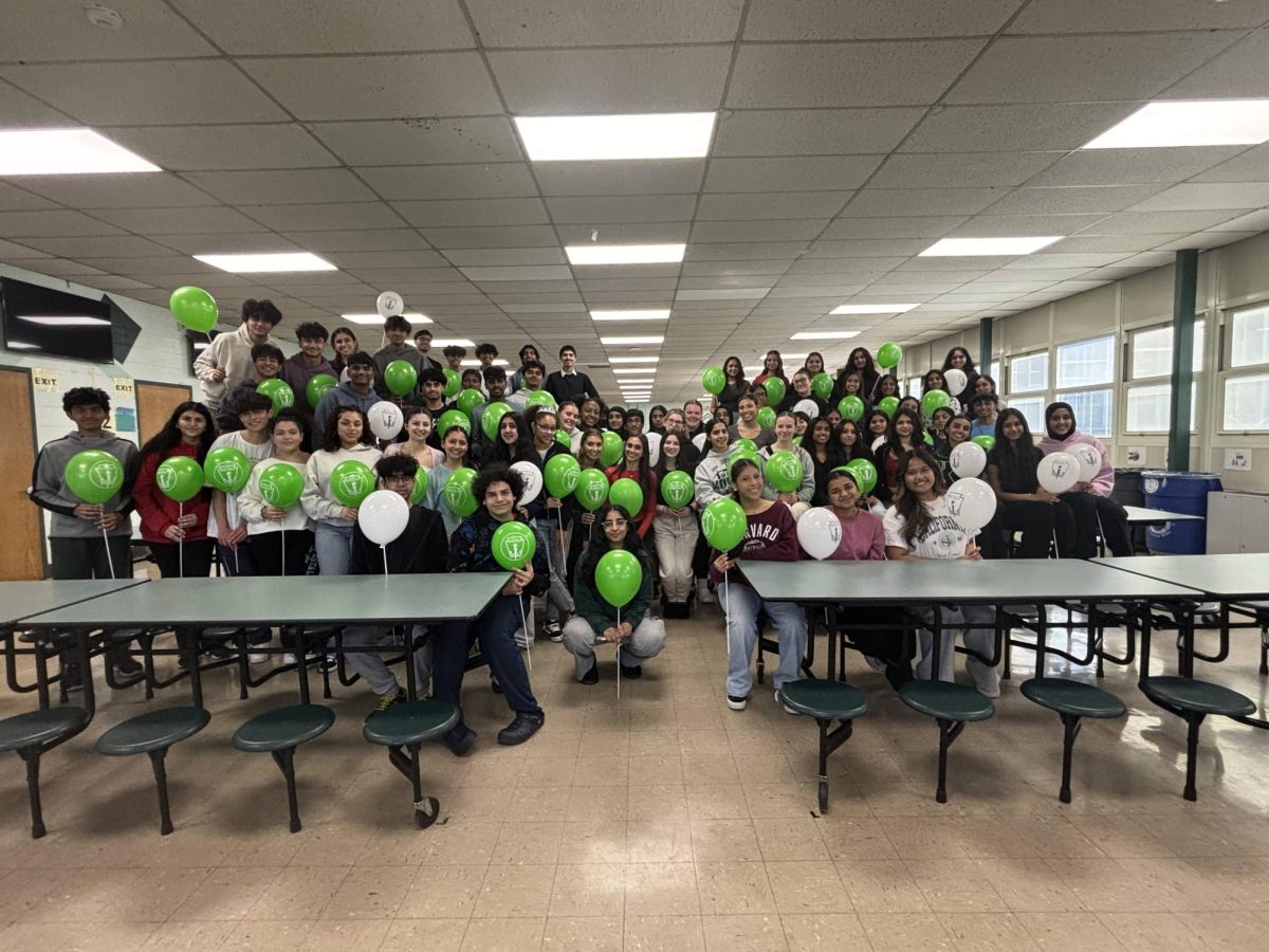 National Honor Society's new inductees smile as they celebrate their accomplishment with their balloons. 
