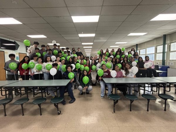National Honor Society's new inductees smile as they celebrate their accomplishment with their balloons. 
