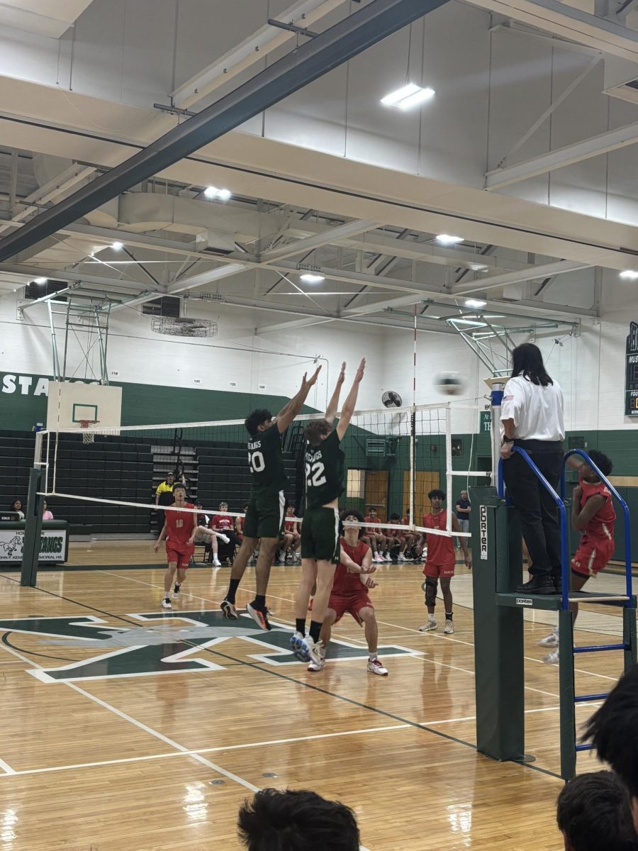 Senior Aryan Patel and junior Wiktor Dabkowski try to block the ball to avoid EHS from gaining a point. 