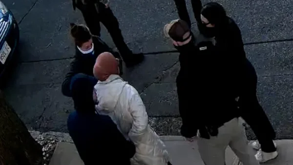 Still frame of student Rumeysa Ozturk being approached by six unidentified men wearing masks claiming to be ICE agents, in Somerville, Mass., on Tuesday, March 25, 2025. 