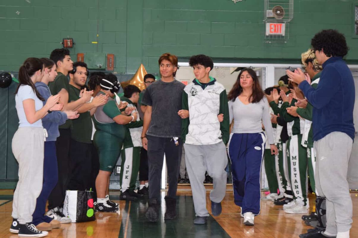 Diego Montoya walking out with his brother and sister on senior night. 