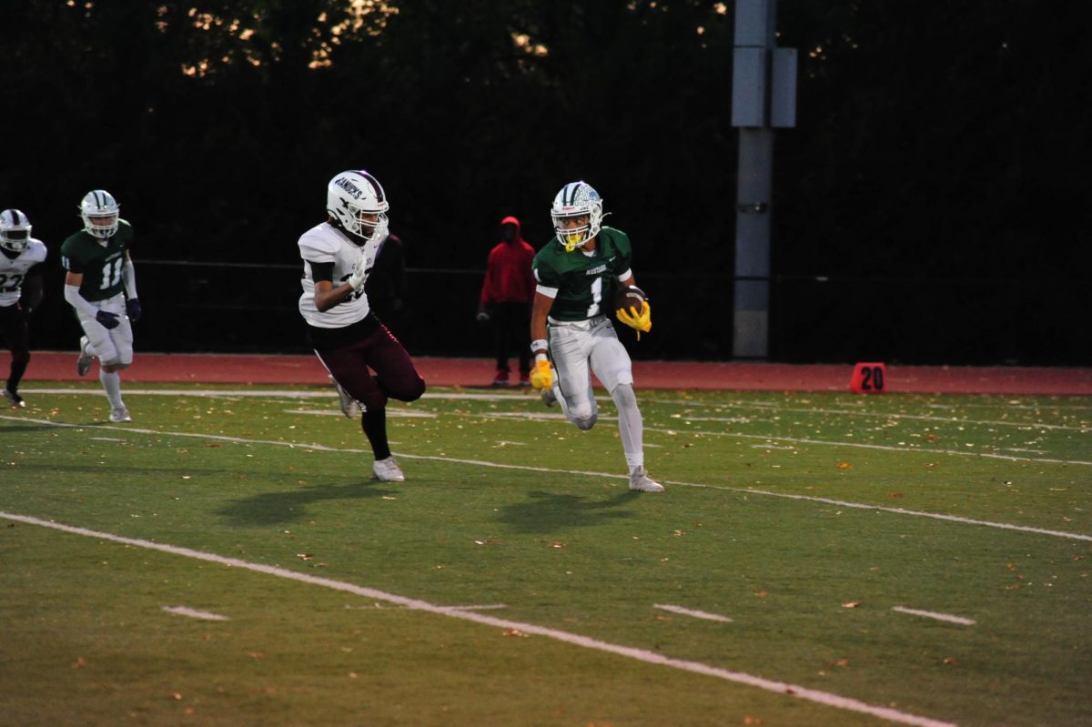 Senior Lee Tobon running down the football field to score a touchdown on senior night. 
