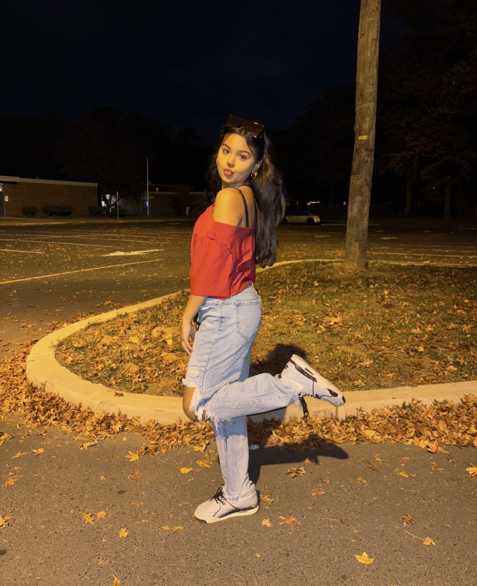 Yana, poses wearing an Alvin costume from Alvin and the chipmunks for Halloween.