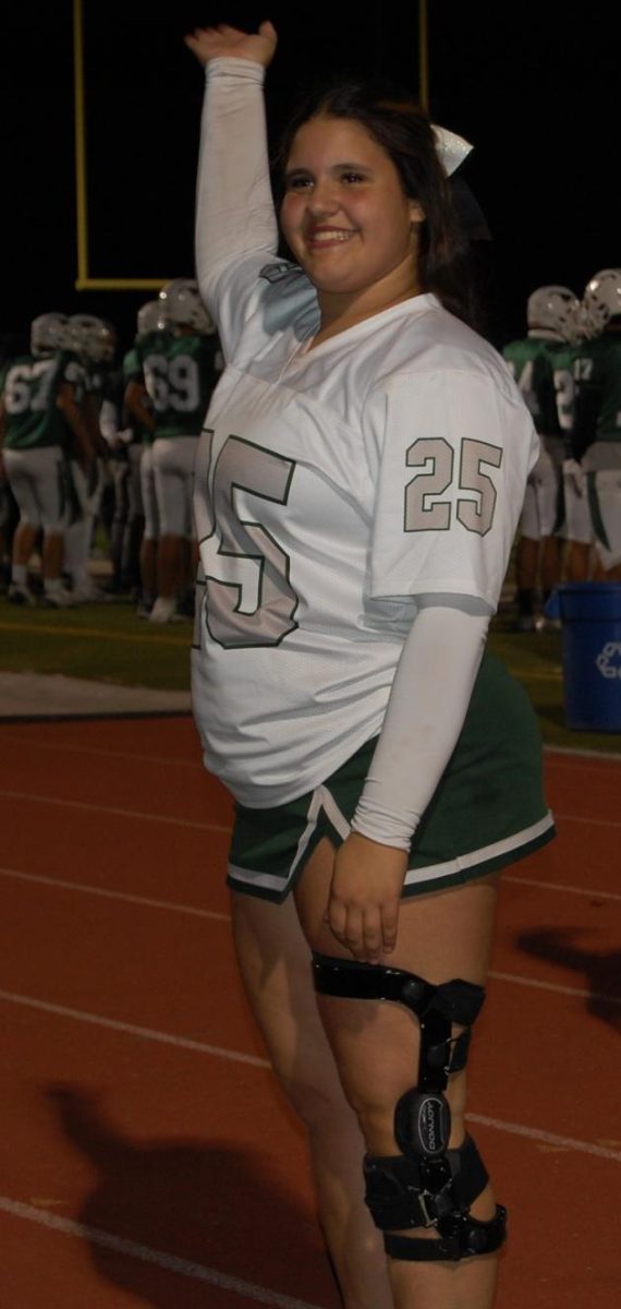 Senior Aryanna Dlugosz cheering her last Friday night lights game  on senior night 